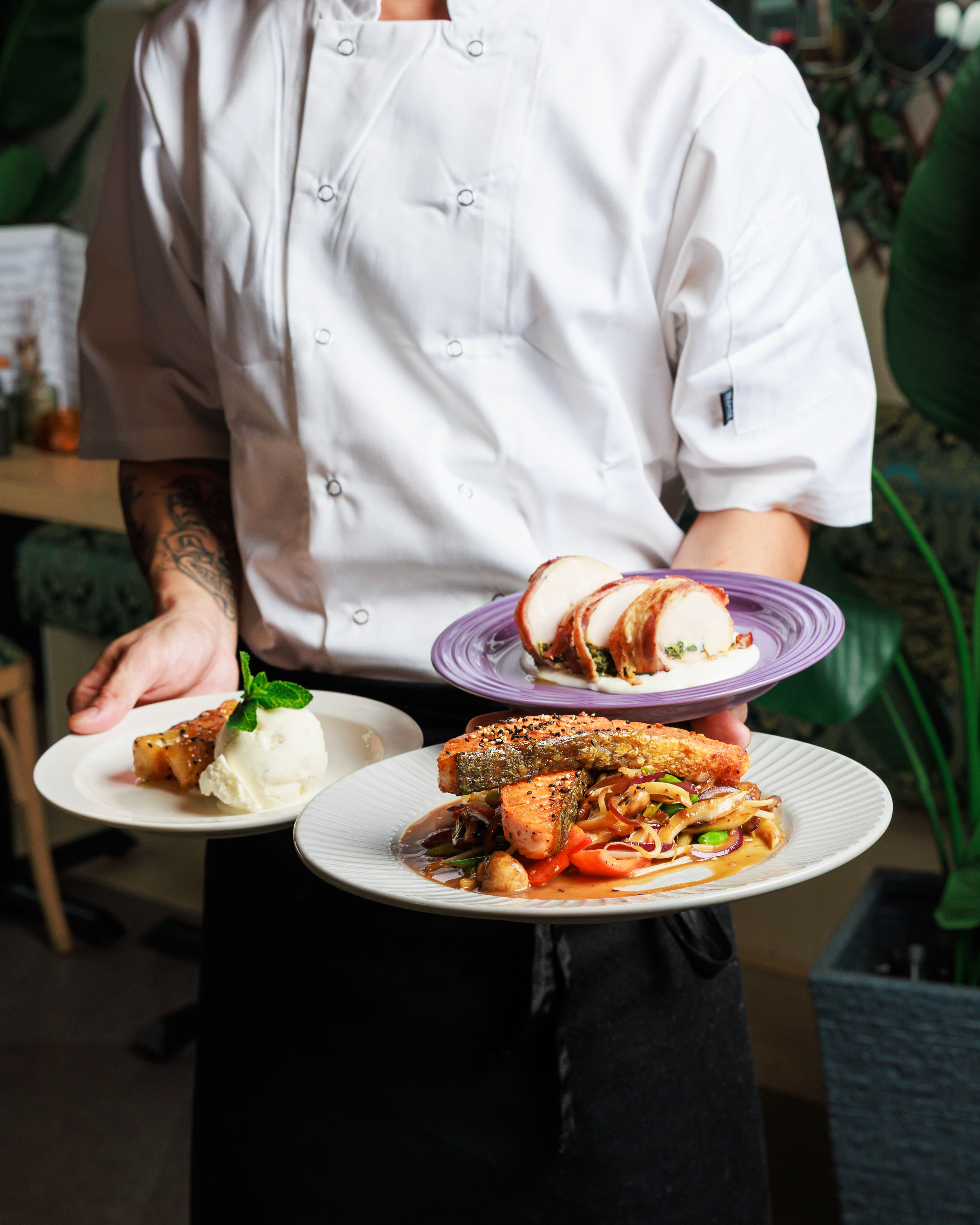 Chef presenting finished dishes during a restaurant shoot