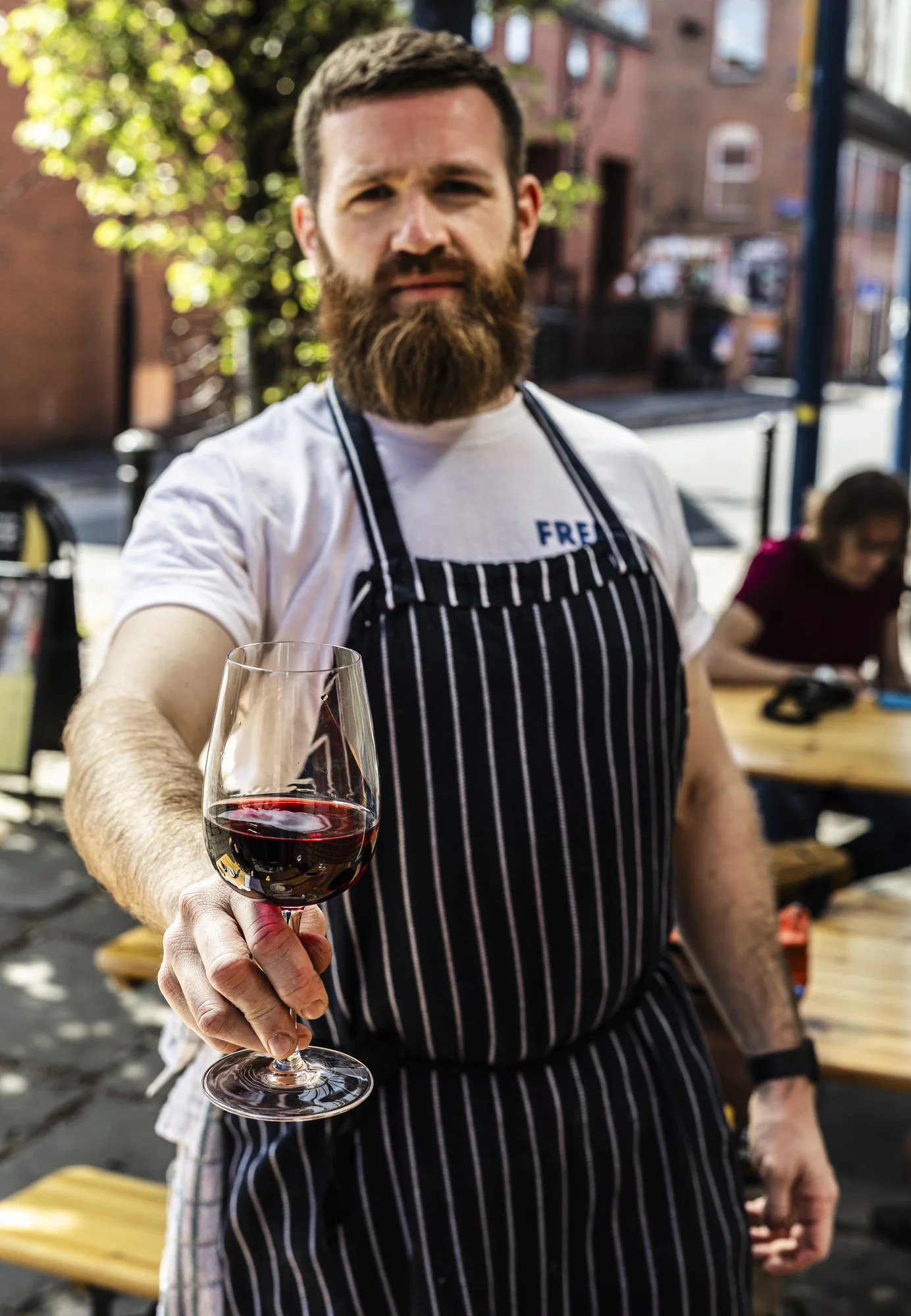 Restaurant chef holding a glass of red wine
